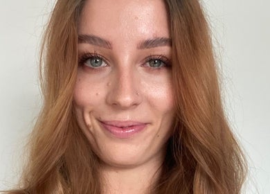 Smiling woman receiving beauty treatment at HTR Aesthetics, Bristol, England, GB.