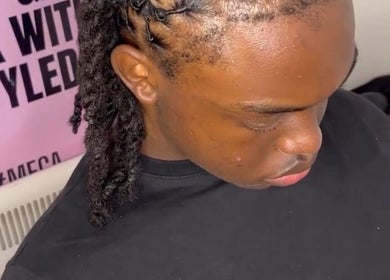 Intricate braided hairstyle at TC Styledit, Nottingham, England, GB showcases precise styling techniques.
