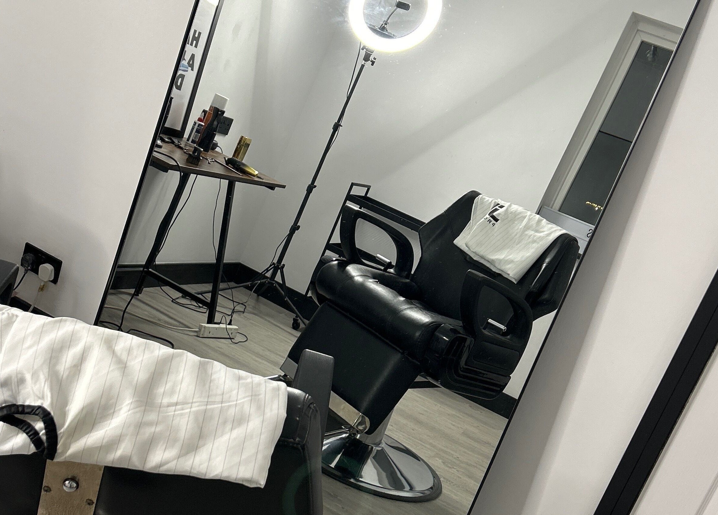 Modern barber chair at LS Cuts in Scunthorpe, England, GB with sleek styling tools.