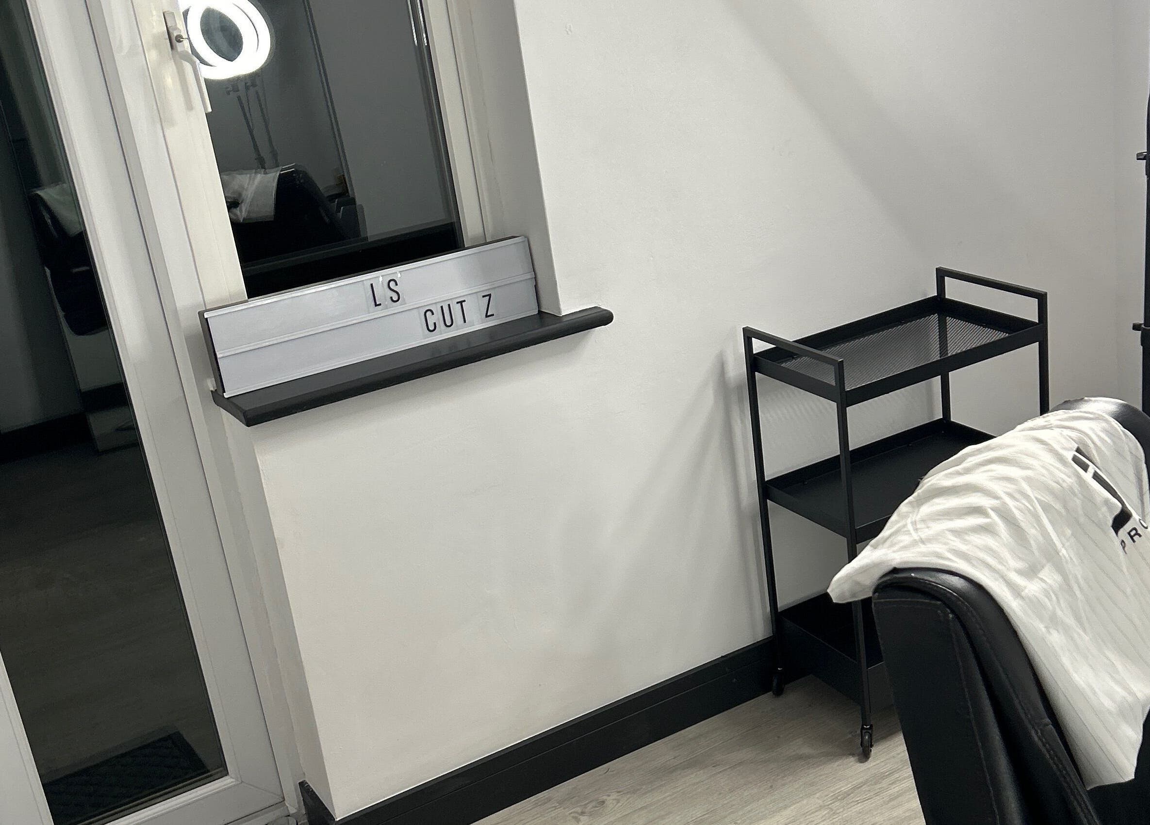 Modern styling chair and station at LS Cuts in Scunthorpe, England, GB, showcasing sleek salon interior.