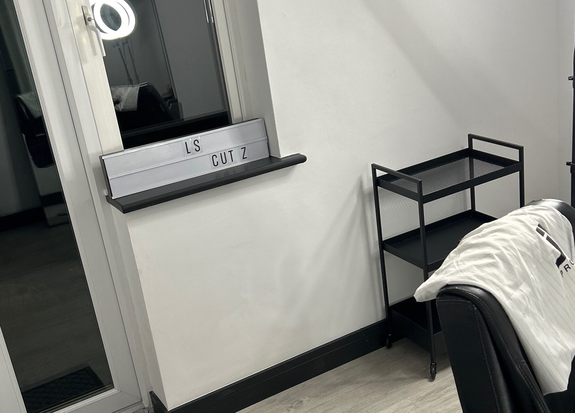 Modern styling chair and station at LS Cuts in Scunthorpe, England, GB, showcasing sleek salon interior.
