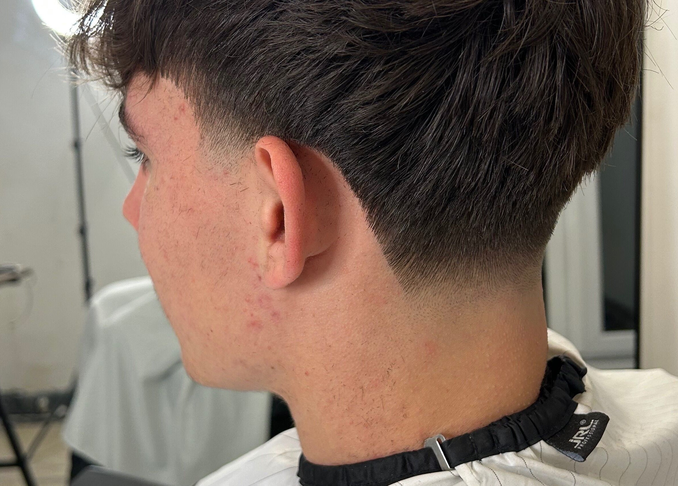 Detailed side view of a fresh haircut at LS Cuts, Scunthorpe, England, GB showcasing a precise fade.