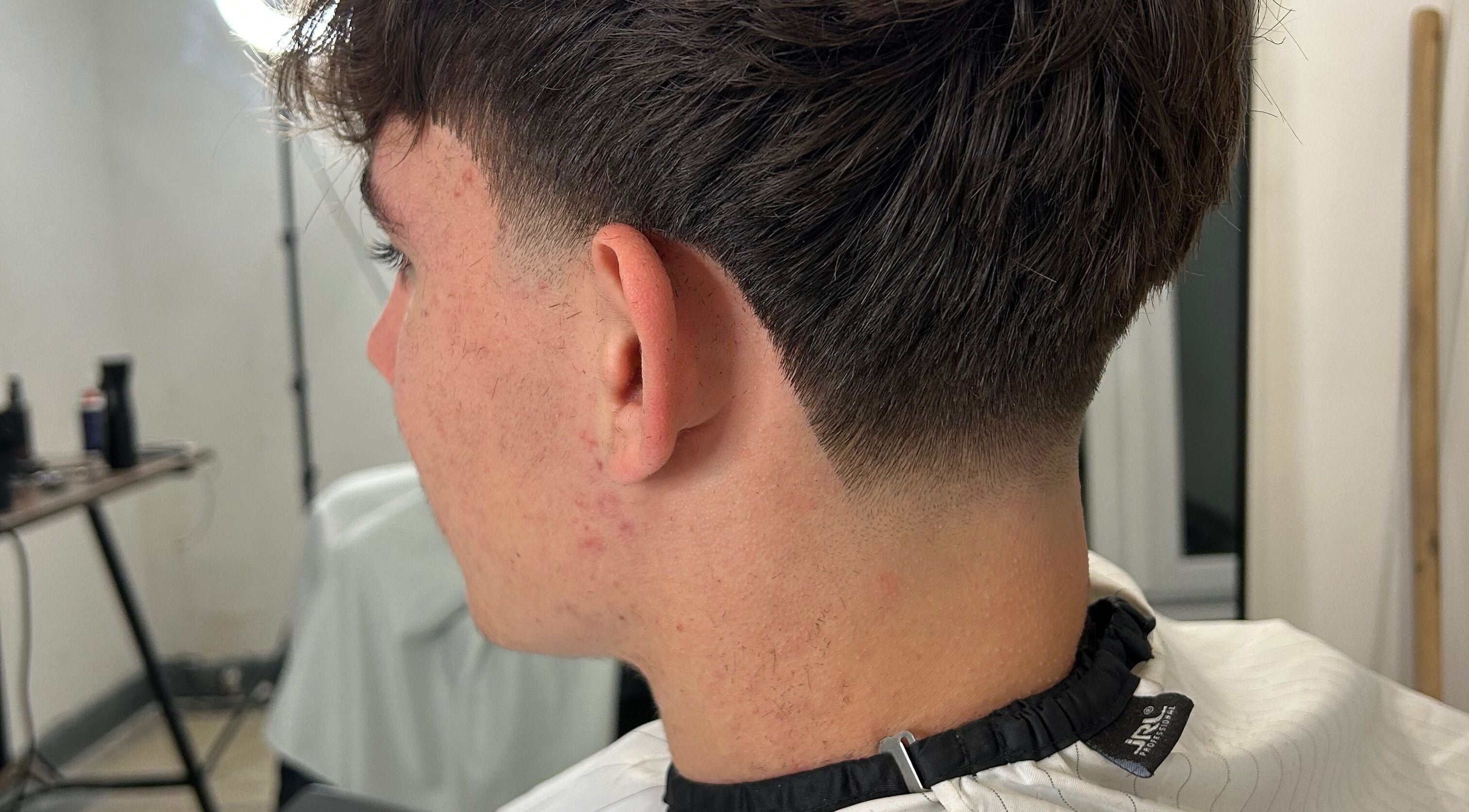 Detailed side view of a fresh haircut at LS Cuts, Scunthorpe, England, GB showcasing a precise fade.