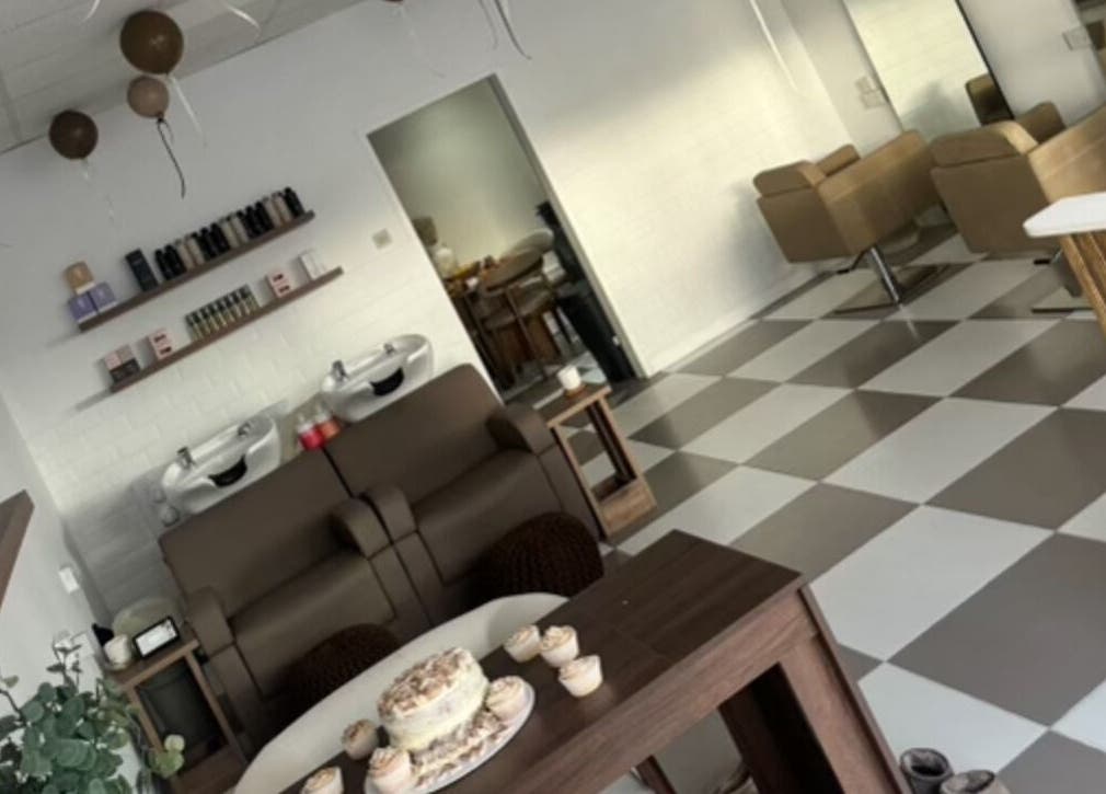 Interior of Fawn Studios, a chic beauty venue in Hyde, England. Modern salon chairs and decor on checkered floor.