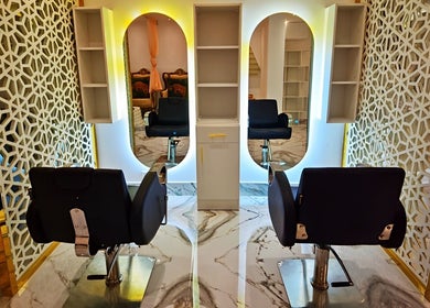 Luxurious salon chairs and ornate mirrors at Thai House Beauty and Spa, Abu Dhabi, AE.