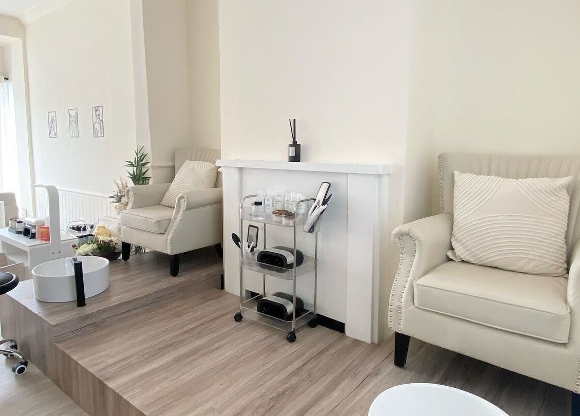 Cozy relaxation area at Irini's Beauty Salon, Brighton And Hove, with plush chairs and manicure setup.