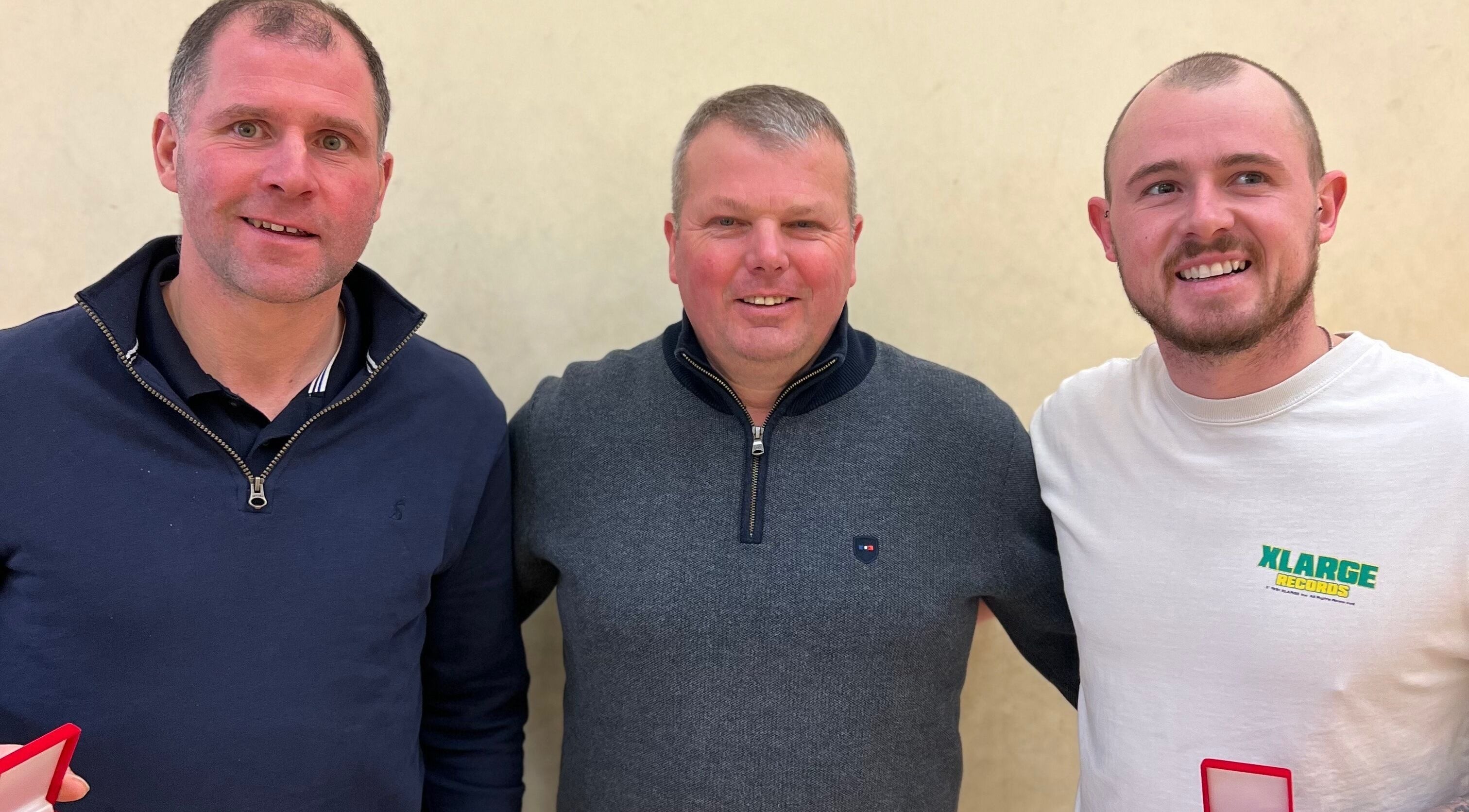 Three individuals smiling together at Saval Handball, Newry, Northern Ireland, GB.