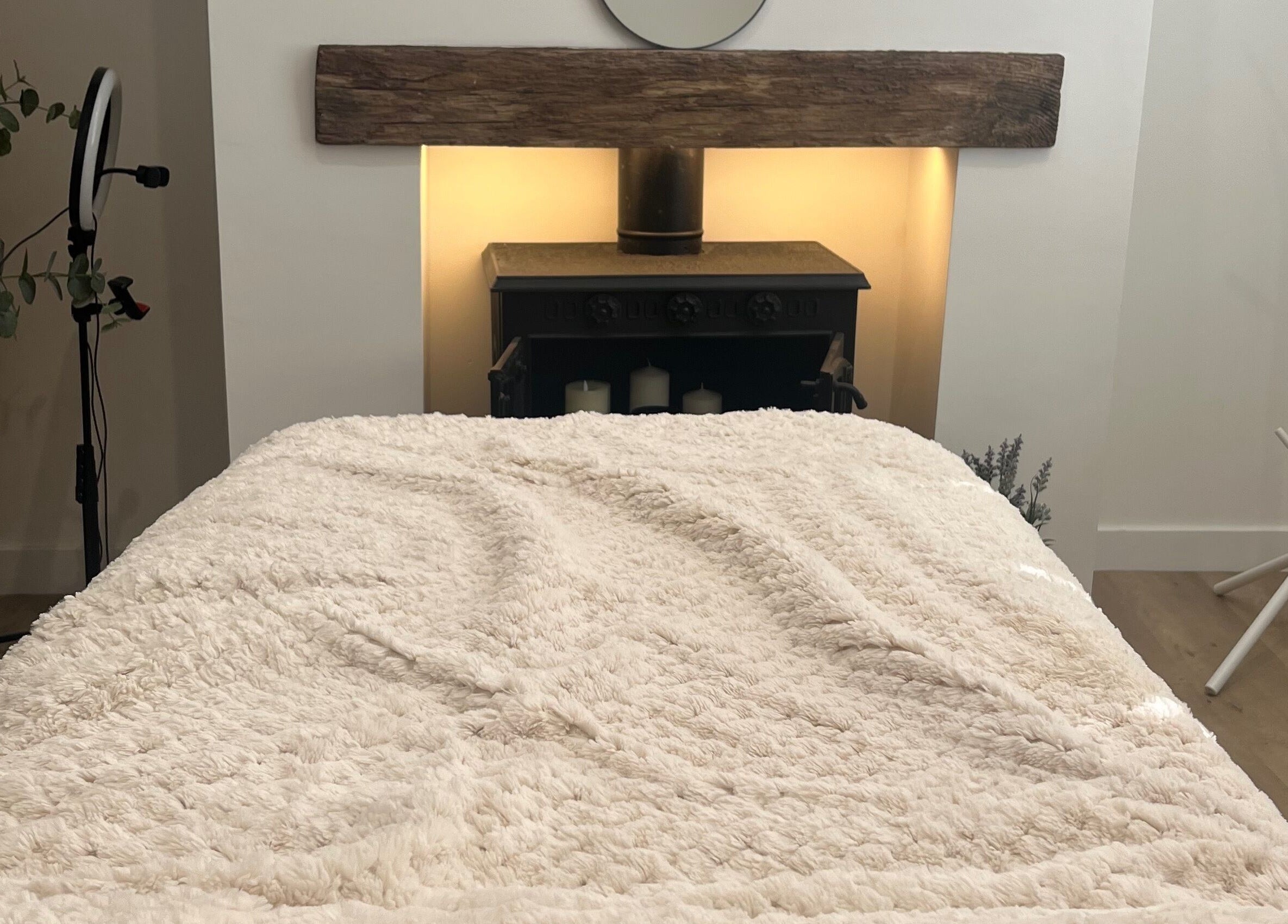 Cozy treatment room at The Glow Collective, Lichfield, England, GB, featuring a plush bed and calming decor.