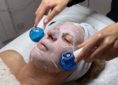 Facial treatment at The Glow Collective in Lichfield, England, GB featuring cooling blue therapy globes.