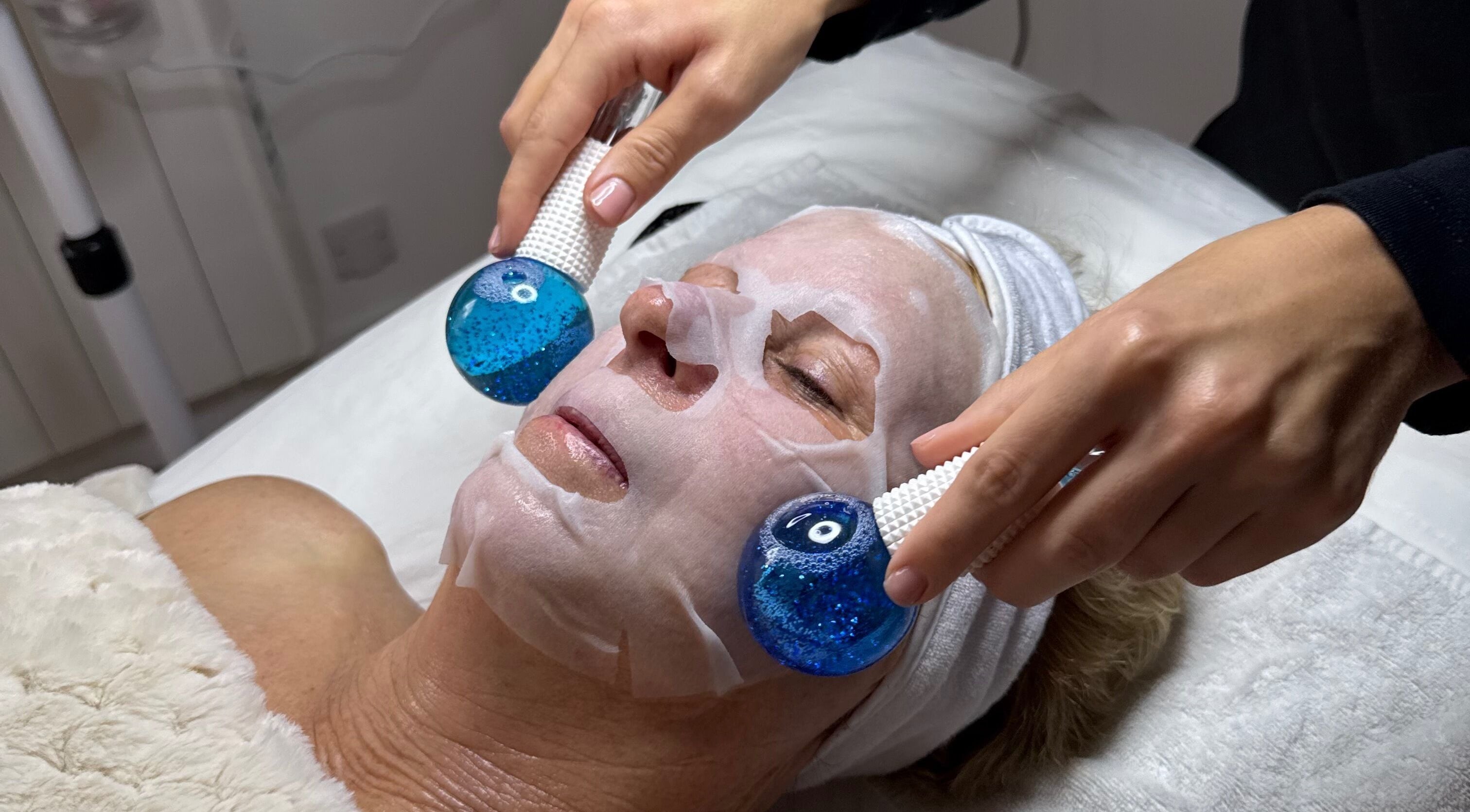 Facial treatment at The Glow Collective in Lichfield, England, GB featuring cooling blue therapy globes.