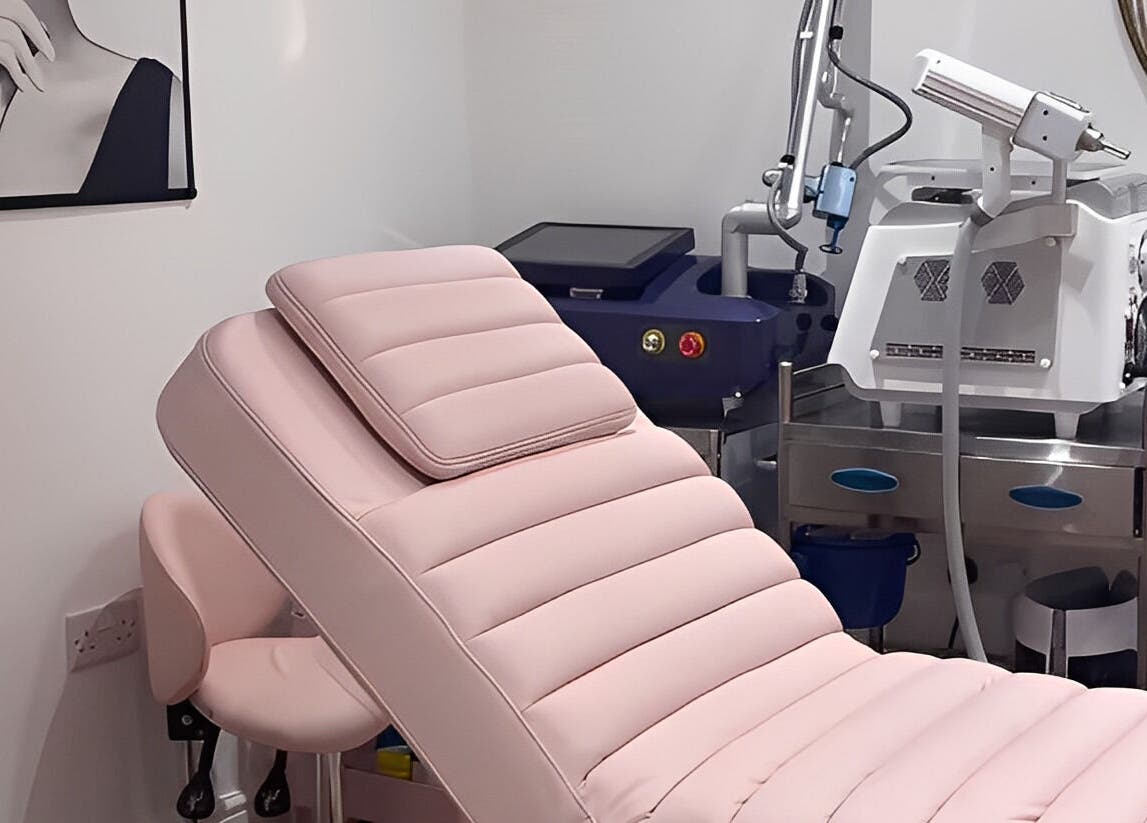 Luxurious treatment room at Ethereal Aesthetics, London, England, GB with modern equipment and pink therapy chair.