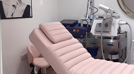 Luxurious treatment room at Ethereal Aesthetics, London, England, GB with modern equipment and pink therapy chair.