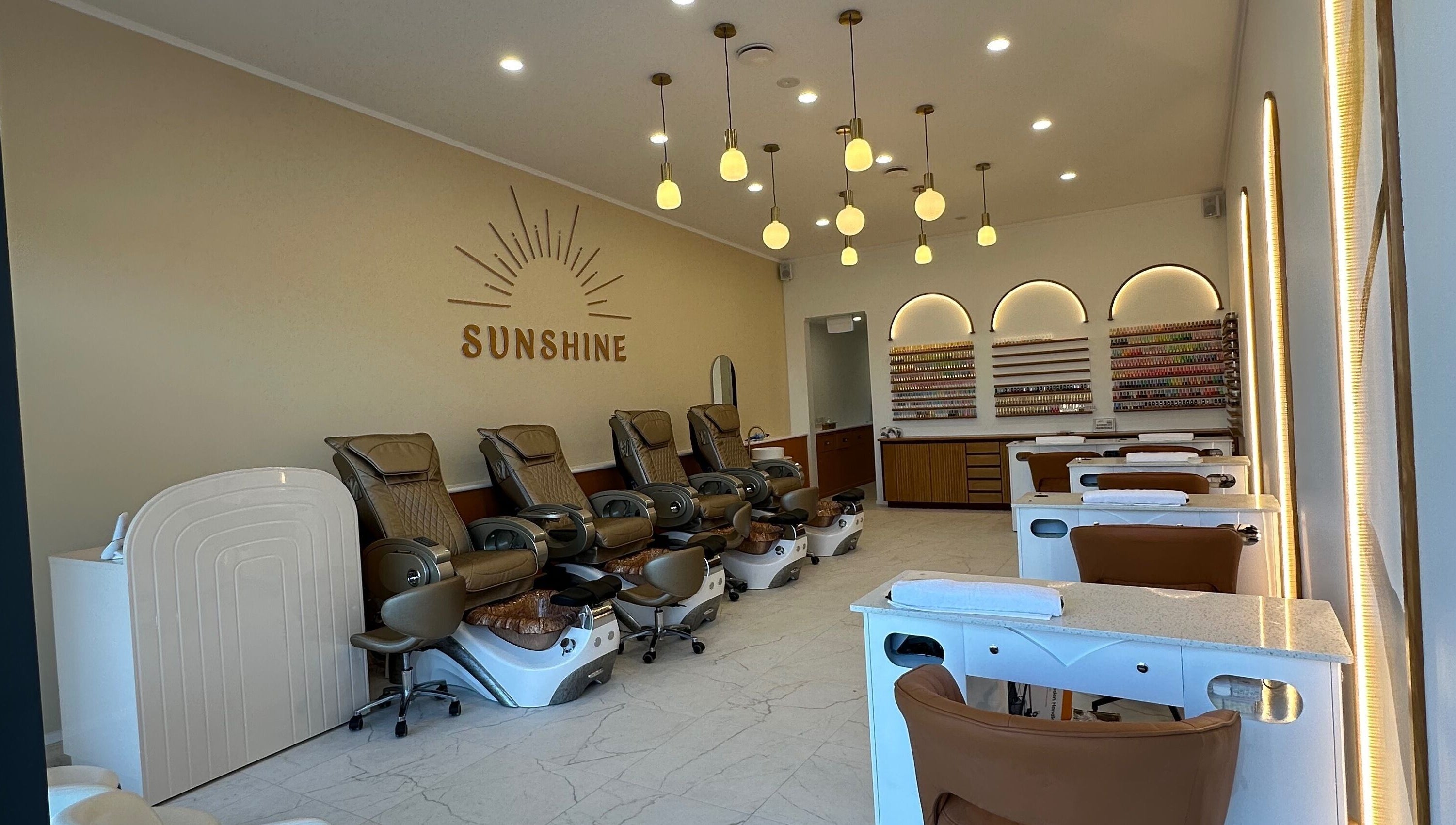 Chic interior of Sunshine Nails & Beauty in Auckland, Auckland, NZ featuring luxurious spa chairs and nail stations.