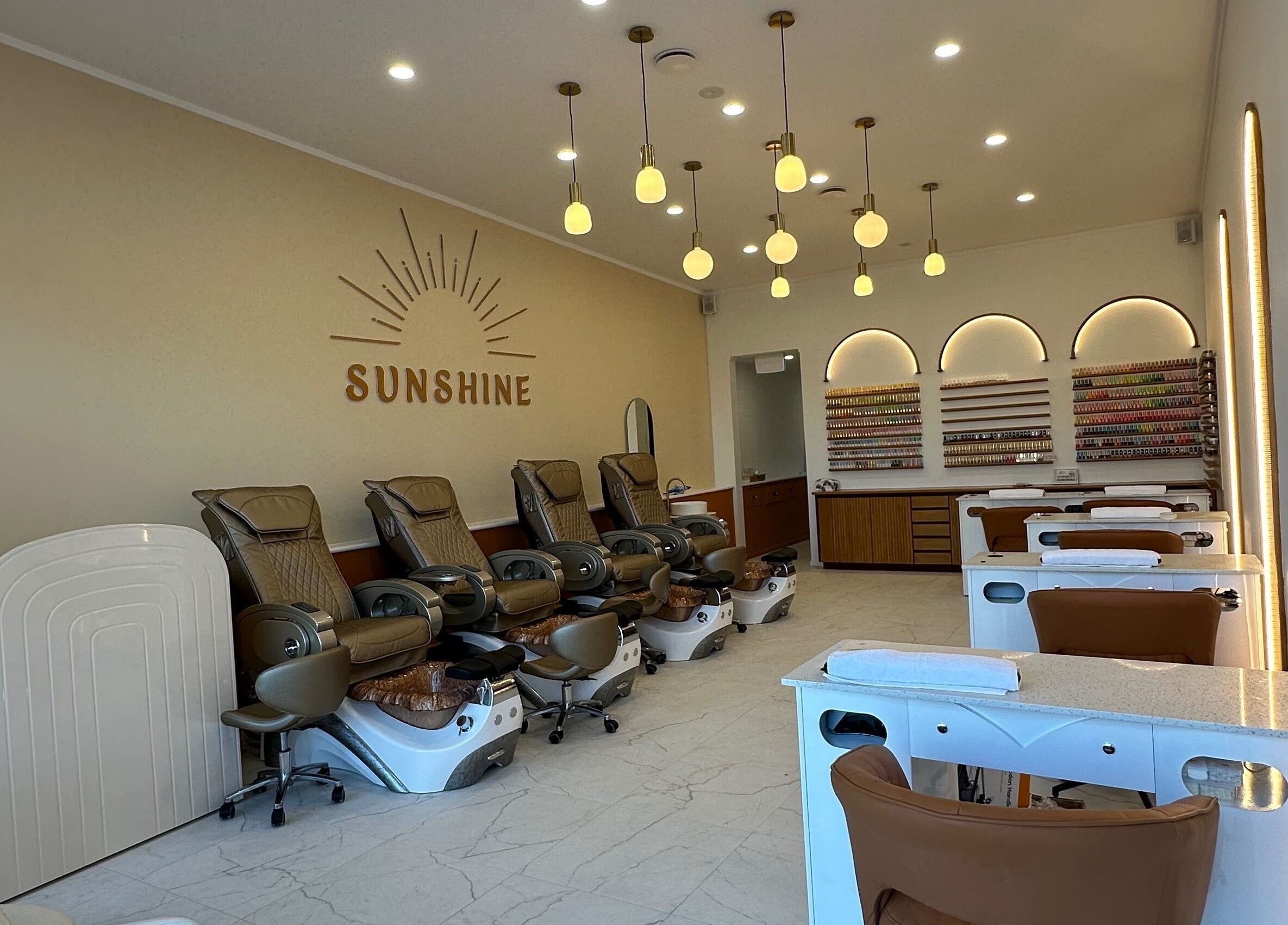 Chic interior of Sunshine Nails & Beauty in Auckland, Auckland, NZ featuring luxurious spa chairs and nail stations.