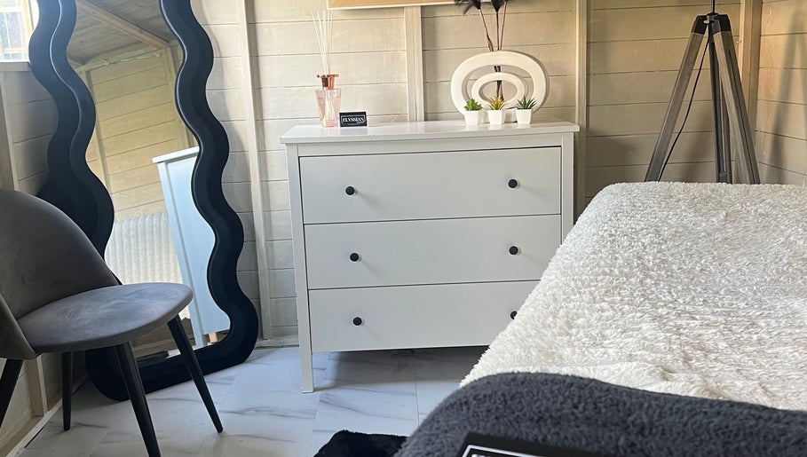 Cozy treatment room at Elyssian - Skincare & Beauty in Southport, England, GB, featuring a sleek mirror and chic decor.