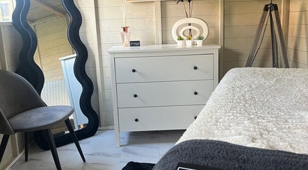 Cozy treatment room at Elyssian - Skincare & Beauty in Southport, England, GB, featuring a sleek mirror and chic decor.