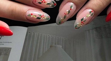 Festive red and green nail art at CutieNailStudio, Glendora, California, US showcasing intricate design.