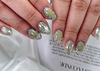 Shiny green nails with art detail at CutieNailStudio, Glendora, California, US, showcasing elegant designs.