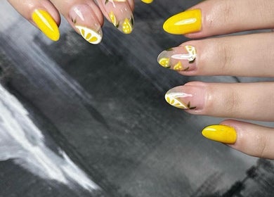 Bright yellow and floral nail designs at Cutie.NailStudio, Glendora, California, US showcasing artistic flair.