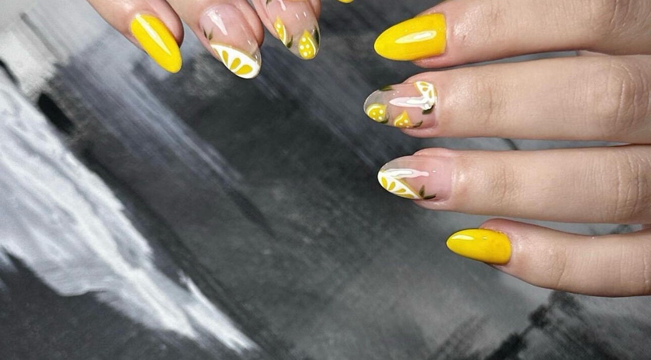 Bright yellow and floral nail designs at Cutie.NailStudio, Glendora, California, US showcasing artistic flair.