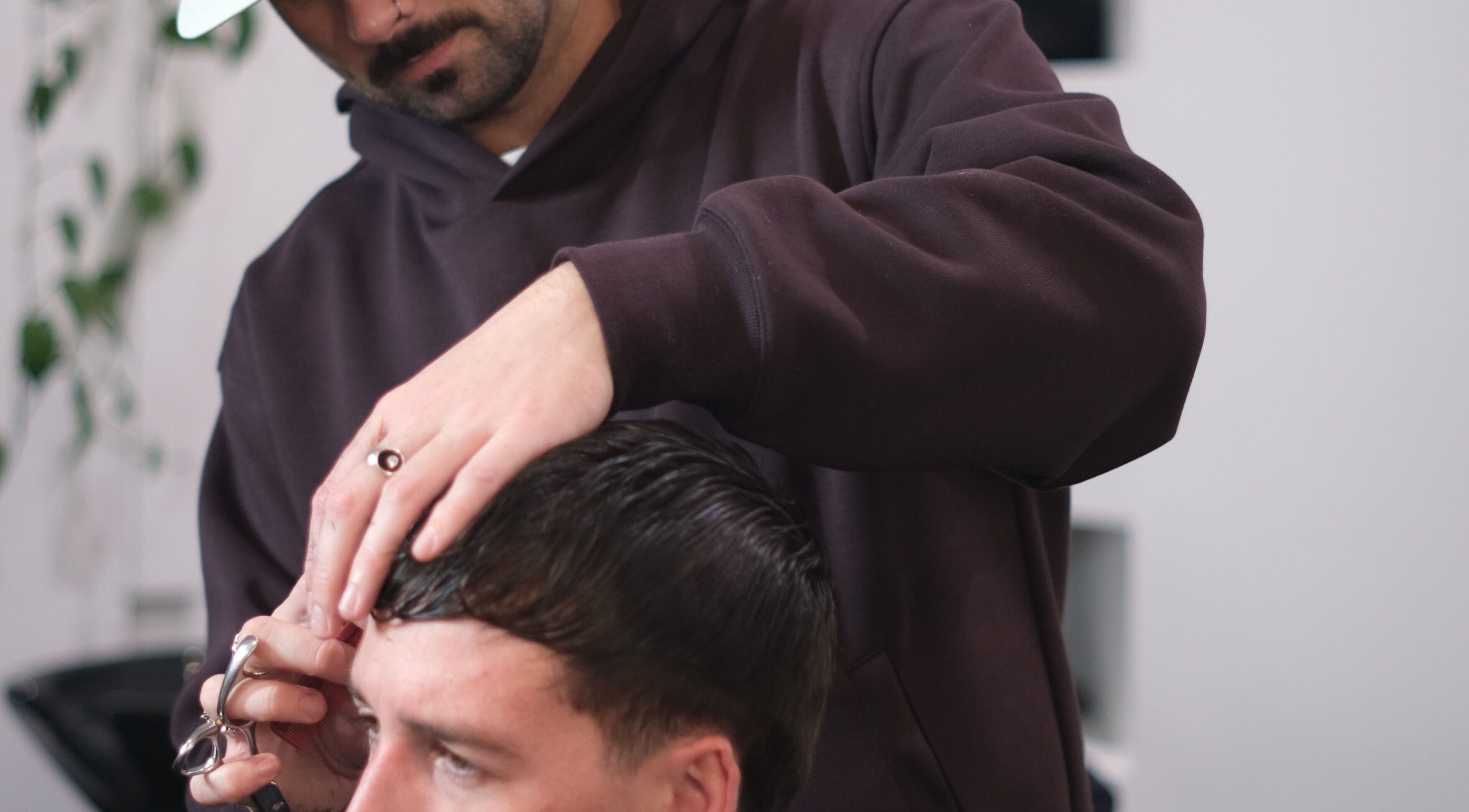 PodgeHealy Hair stylist precision-cutting hair in Bondi Junction, New South Wales, AU.