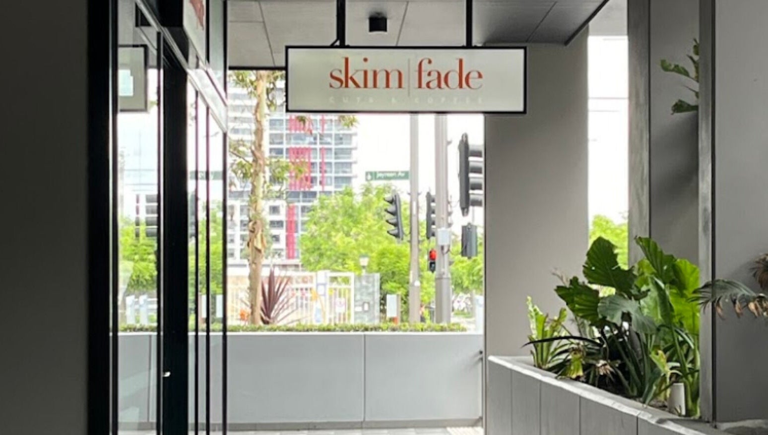 SkimFade salon exterior in Zetland, New South Wales, AU, showcasing urban style and greenery.