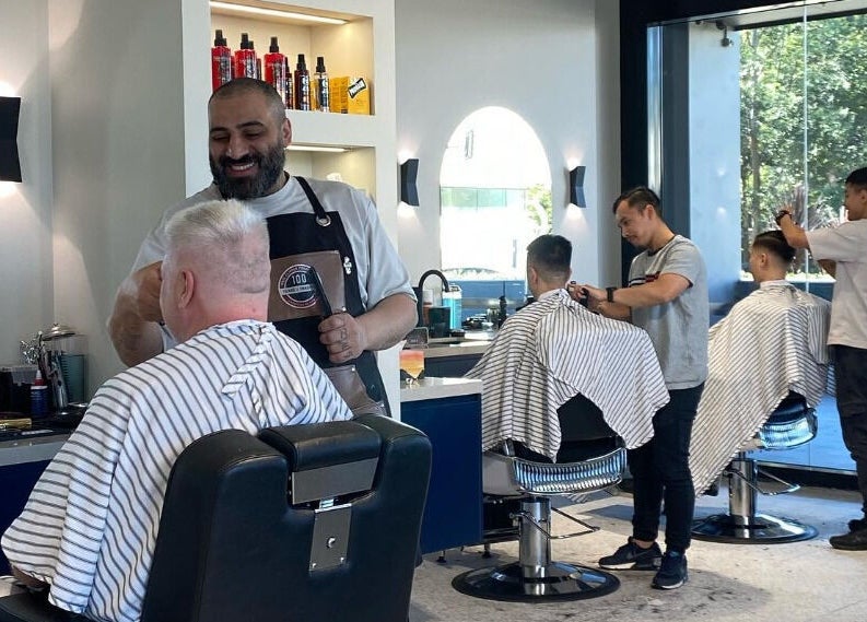 Barbers at SkimFade in Zetland, New South Wales, AU crafting stylish haircuts for clients in a modern setting.