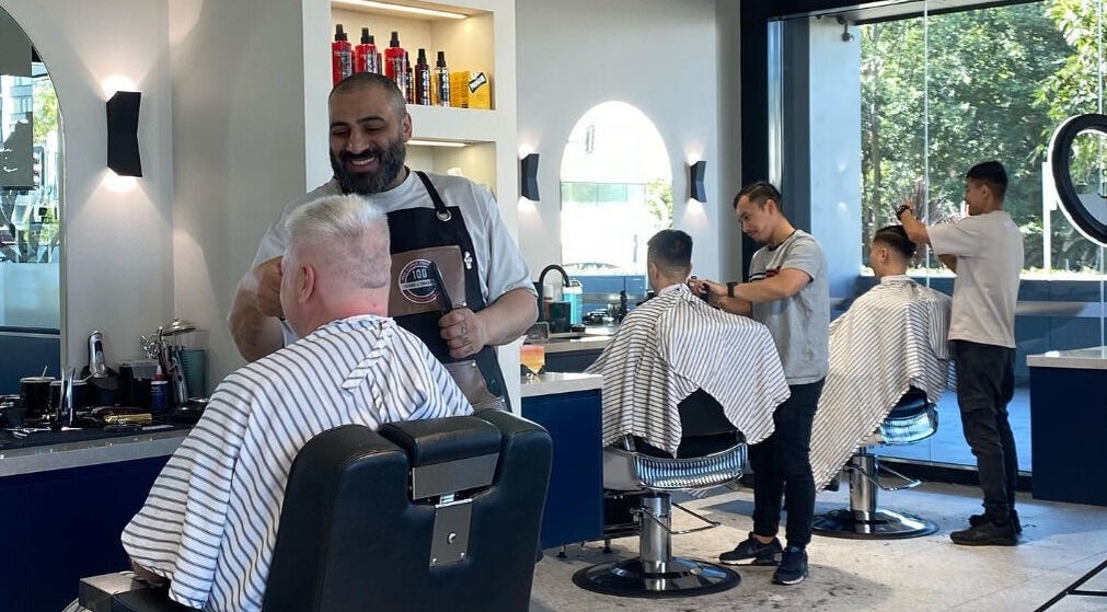 Barbers at SkimFade in Zetland, New South Wales, AU crafting stylish haircuts for clients in a modern setting.