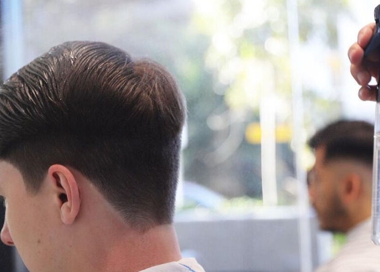 Close-up of a precise haircut at SkimFade, Zetland, New South Wales, AU, with a stylist using water spray.