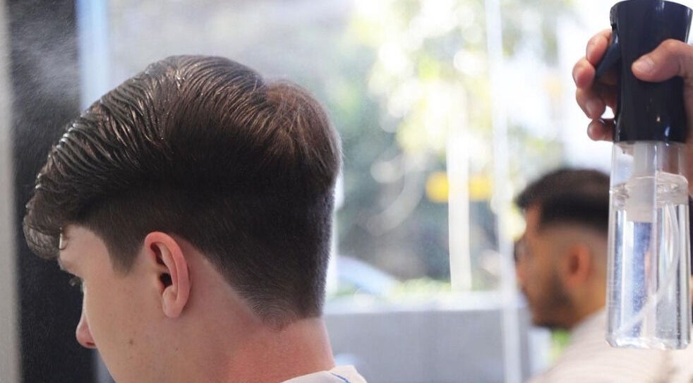 Close-up of a precise haircut at SkimFade, Zetland, New South Wales, AU, with a stylist using water spray.
