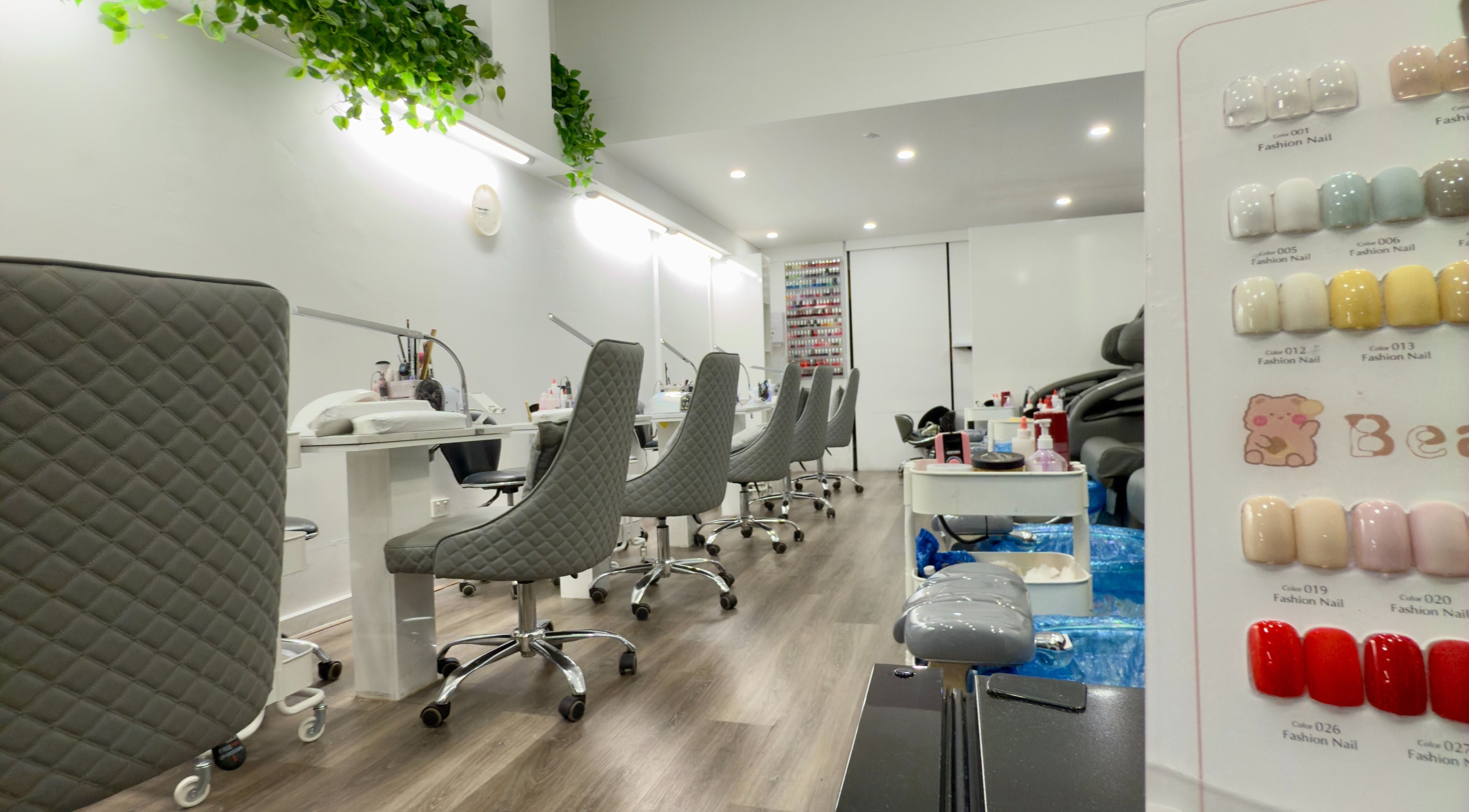 Interior of Moncheri Nails in Melbourne, Victoria, AU featuring modern chairs and a nail polish display.