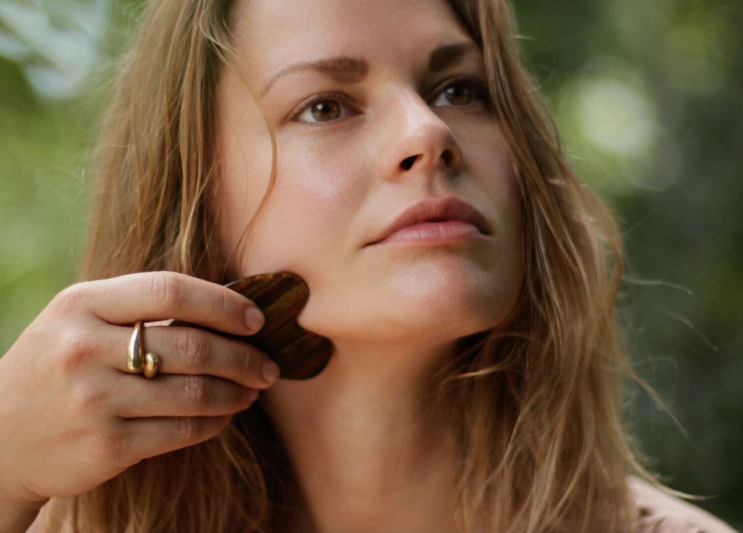 Woman using Gua Sha tool at Star Seed + Yoga With Nics, Clapham, London, England, GB.