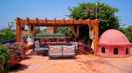 Charming oasis at Star Seed + Violet Stopford Retreat Popup in London, England, GB with lush greenery and seating.