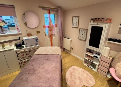 Chic interior of The Pink Beauty Room in Huddersfield, England, GB, featuring a cozy treatment area.