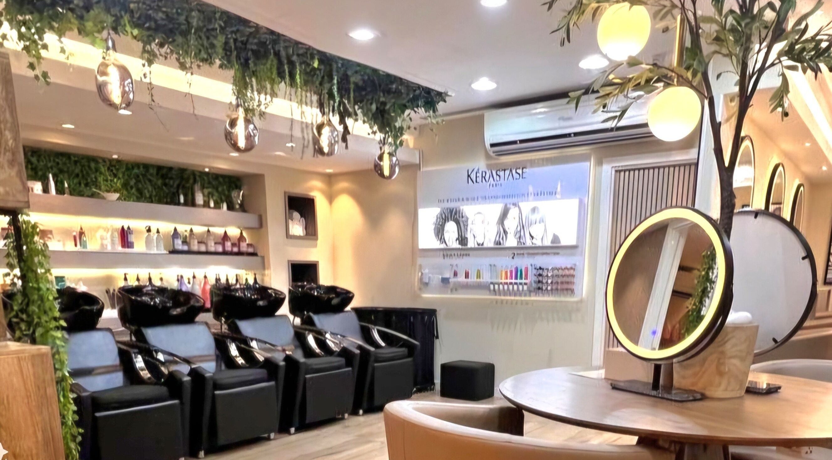 Inside Version Francaise - Hair & Beauty Salon, Dubai, Dubai, AE, showcasing chic styling stations and greenery.
