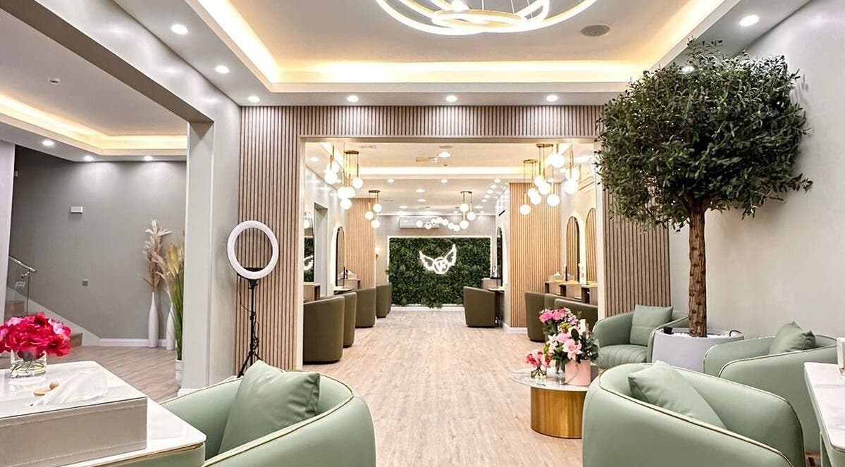 Elegant interior of Version Francaise Pour Elle in Dubai, AE, featuring green decor and modern lighting.