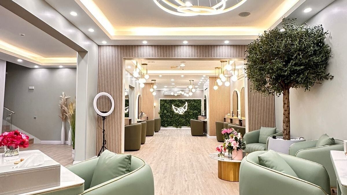 Elegant interior of Version Francaise Pour Elle in Dubai, AE, featuring green decor and modern lighting.