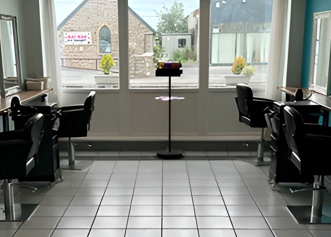 Bright salon space at La’torias at Kidwelly, featuring sleek styling chairs and mirrors in Kidwelly, Wales, GB.