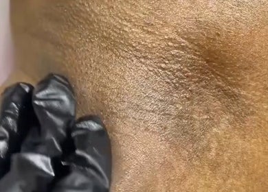 Gloved hand massaging skin at HONEYBODY BEAUTY BAR & THE LOC HIVE in May Pen, Clarendon, JM.