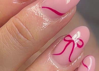 Stylish pink manicure with bow design at Empire Beauty, Liverpool, England, GB.