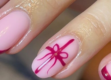Stylish pink and red nail art at Empire Beauty, Liverpool, England, GB, showcasing intricate design.