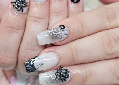 Intricate spider and web nail art at Nail Tip in Jacksonville, Florida, US showcasing expert design.