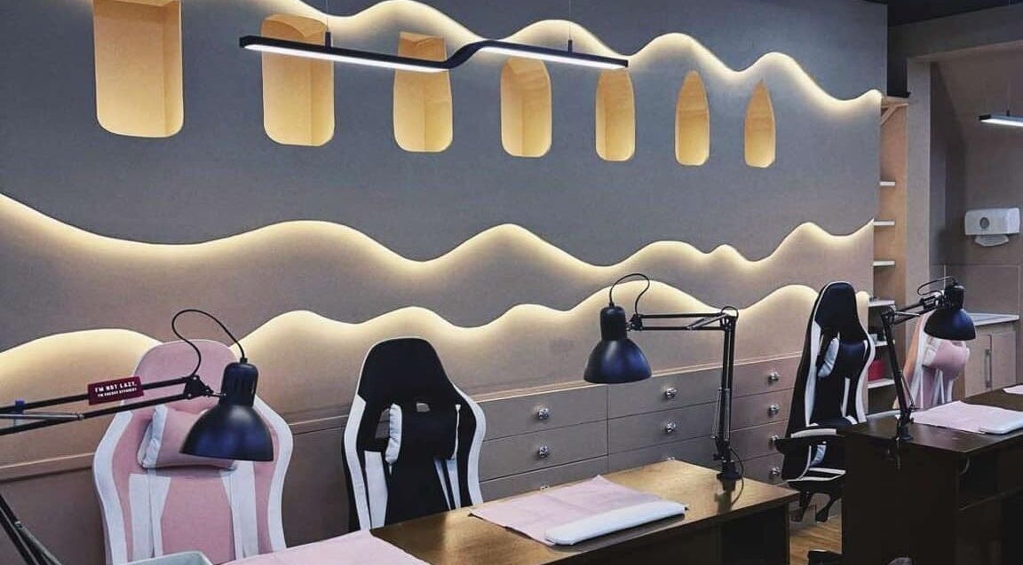 Elegant nail station at NailPlug, Urmston, England, GB with modern lighting and ergonomic chairs.