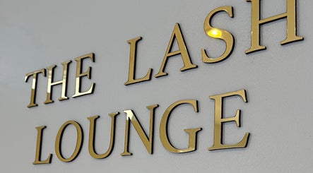 Golden lettering of THE LASH LOUNGE on a wall in Abersychan, Wales, GB.