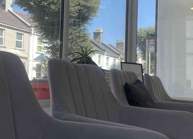 Spacious waiting area with stylish chairs at Hair & Makeup by Galyna Shchyrba, Plymouth, England, GB.