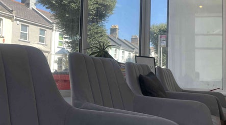 Spacious waiting area with stylish chairs at Hair & Makeup by Galyna Shchyrba, Plymouth, England, GB.