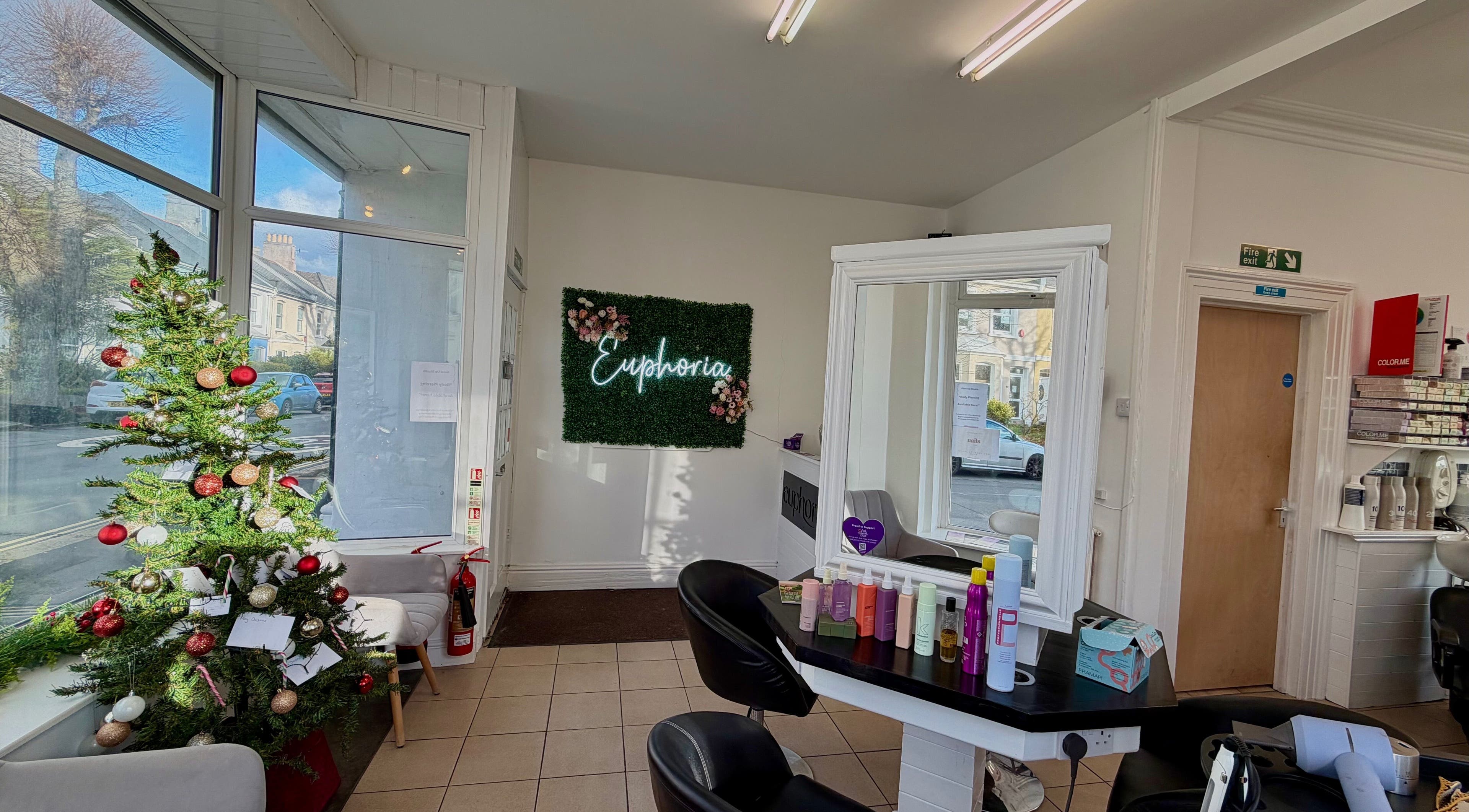 Cozy interior of Hair & Makeup by Galyna Shchyrba, Plymouth, England, with festive Christmas tree.