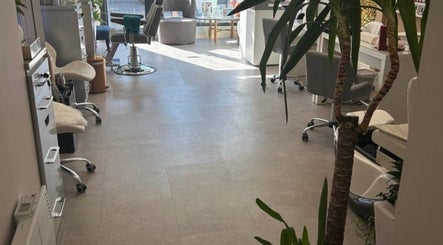 Inside Annayah Aesthetics (Hove), a modern, sunlit salon in Brighton And Hove, England, GB with stylish chairs.