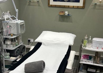 Calming treatment room at Annayah Aesthetics (Hove), Brighton And Hove, England, GB with a spa bed and equipment.