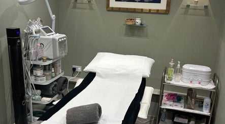 Calming treatment room at Annayah Aesthetics (Hove), Brighton And Hove, England, GB with a spa bed and equipment.